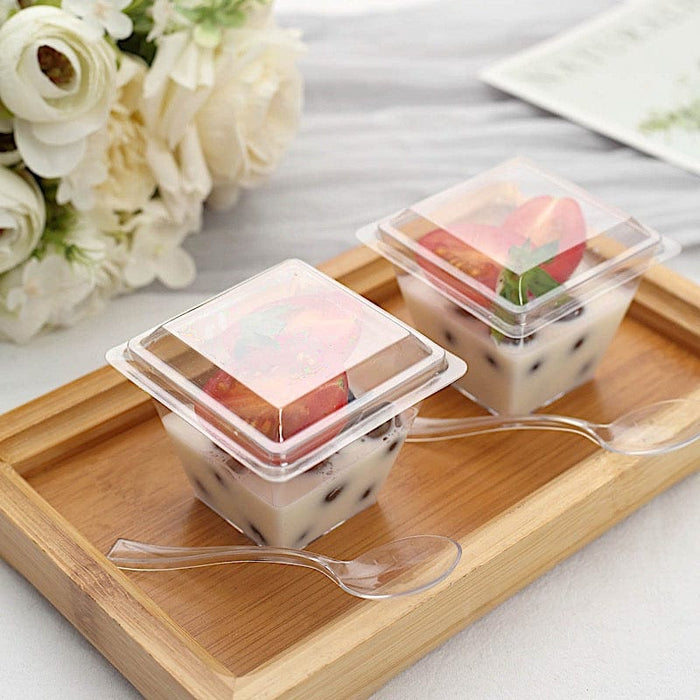 https://leilaniwholesale.com/cdn/shop/files/24-clear-4-oz-square-plastic-dessert-cups-with-lid-and-spoon-set-disposable-tableware-dsp-dst-cu004-4-clr-30783497142335_700x700.jpg?v=1684478215