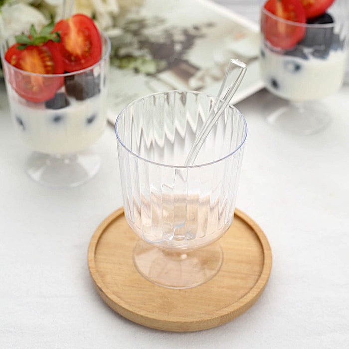 https://leilaniwholesale.com/cdn/shop/files/24-clear-5-oz-ribbed-round-plastic-dessert-cups-with-spoons-set-disposable-tableware-dsp-dst-cu003-5-clr-30789521702975_700x700.jpg?v=1685003461