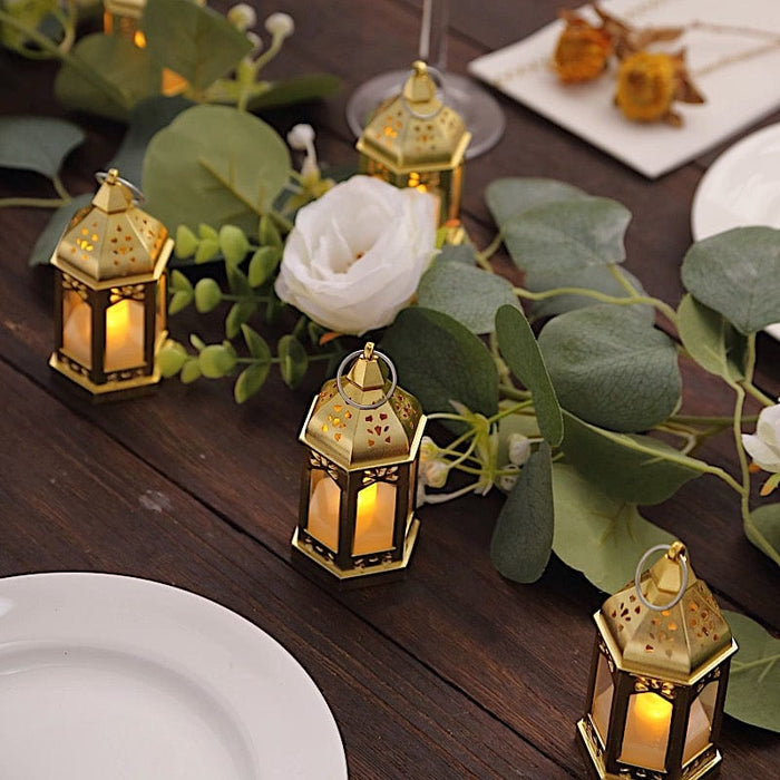 https://leilaniwholesale.com/cdn/shop/files/6-vintage-mini-lantern-with-flickering-led-tealight-candles-gold-led-cand-tl007-clr-31123855409215_700x700.jpg?v=1703818491