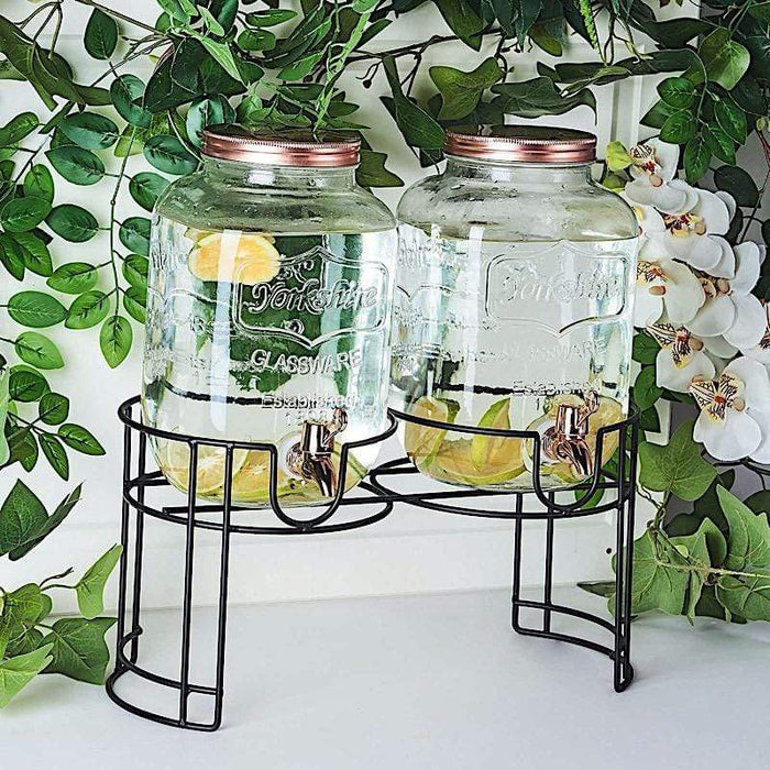 https://leilaniwholesale.com/cdn/shop/products/2-pcs-2-gallons-jar-glass-beverage-dispensers-set-with-spigot-and-stand-clear-and-gold-disp-glas01-1-clr-15814333497407_700x700.jpg?v=1629344598