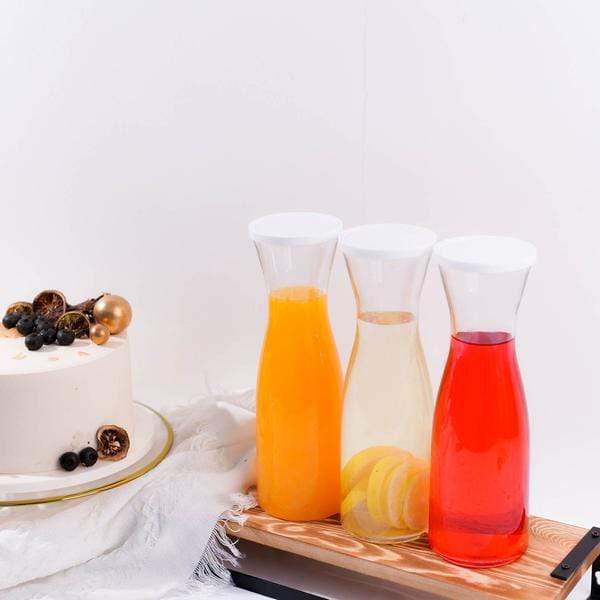 https://leilaniwholesale.com/cdn/shop/products/3-pcs-34-oz-plastic-carafes-with-lids-beverage-jars-clear-and-white-dsp-serv-crf01-34-clr-28537800130623_600x600.jpg?v=1630155676