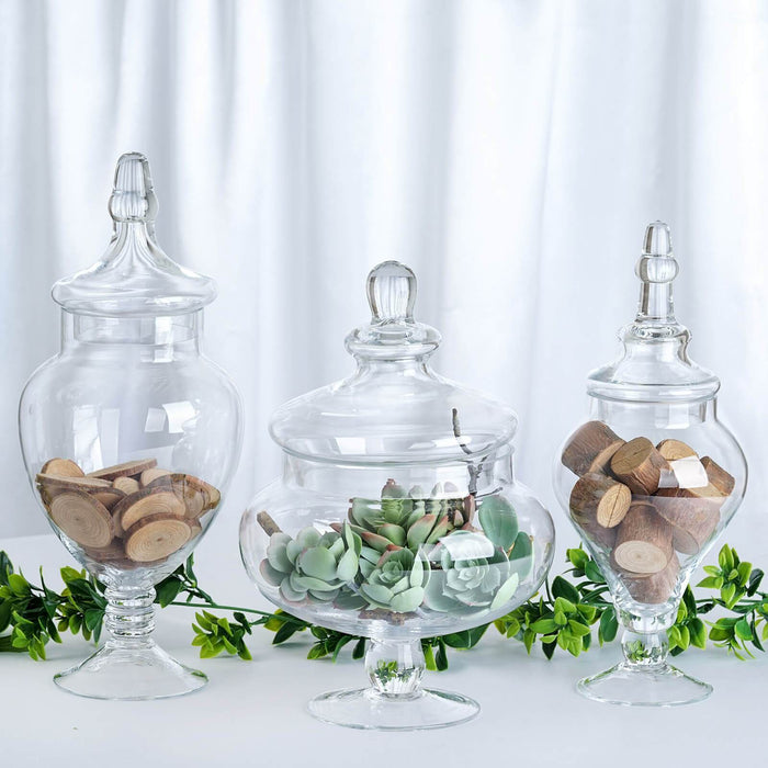 https://leilaniwholesale.com/cdn/shop/products/set-of-3-10-12-14-tall-glass-apothecary-jars-containers-with-lids-clear-glas-jar12-clr-14204797124671_700x700.jpg?v=1630041550